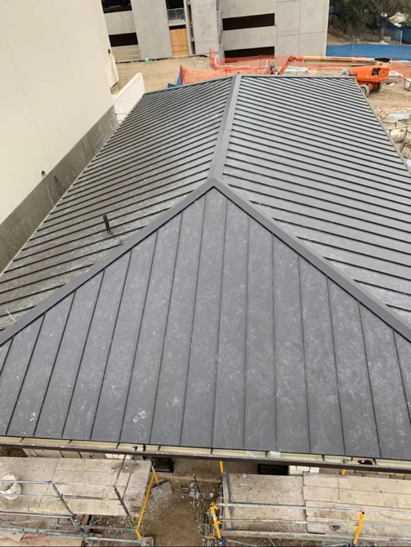 Commercial metal roof construction with crane equipment in Eastern Goleta Valley